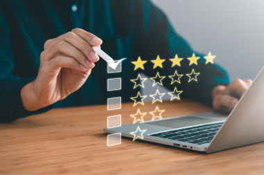 best qualities to look for in a home addition builder homeowner at laptop leaving review custom built michigan