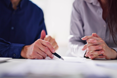 questions to ask before hiring a screened in porch builder homeowner and contractor reviewing remodeling contract custom built michigan