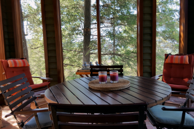 questions to ask before hiring a screened in porch builder covered decking space with outdoor dining table custom built michigan