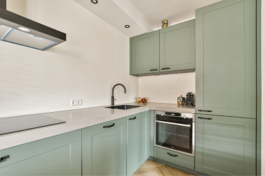 common kitchen layout mistakes homeowners regret later culinary area with induction cooktop and large backsplash custom built michigan