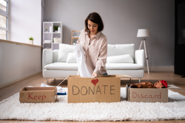interior design ideas to revitalize your home this spring homeowner sorting clothes into donation boxes custom built michigan