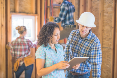 red flags of an unreliable roofing contractor remodeler and homeowner discussing project custom built michigan