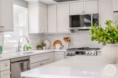luxury kitchen remodeling project in DeWitt Michigan built by Custom Built Design and Remodeling with quartz countertops and subway tile backsplash