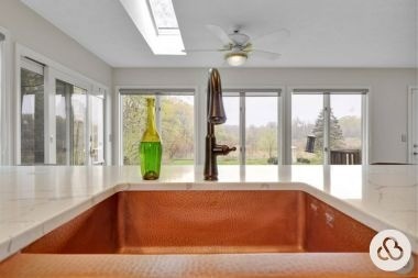 luxury kitchen remodeling project in Mason Michigan built by Custom Built Design and Remodeling with brass sink and bronze faucet