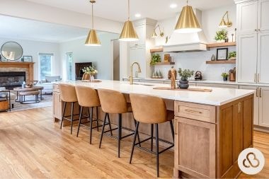 luxury kitchen remodeling project in Mason Michigan built by Custom Built Design and Remodeling with gold finished light fixtures and sink faucet