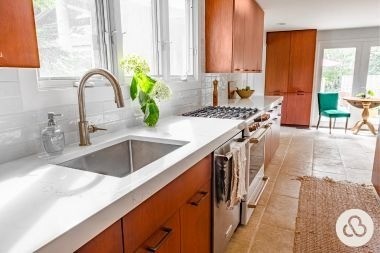 luxury kitchen remodeling project in East Lansing Michigan built by Custom Built Design and Remodeling with resurfaced cabinets and bronze faucet