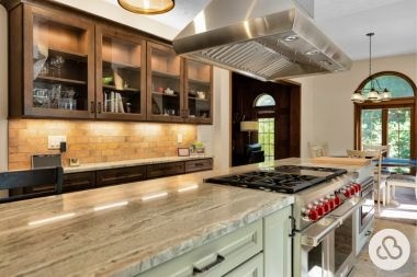 luxury kitchen remodeling project in Okemos Michigan with large island and glass front cabinets