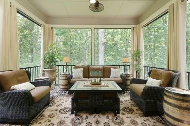 screened in porch with large windows and metal railings