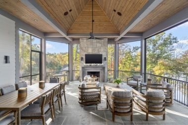 luxury screened in porch with dining table and tv area in Greater Lansing