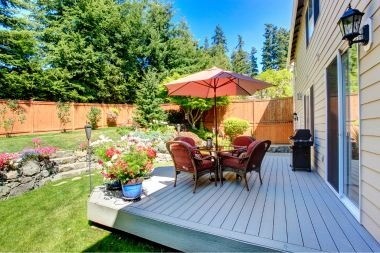 Greater Lansing composite deck outdoor living space with tall privacy fencing