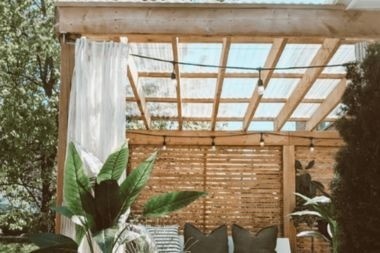 wood pergola with outdoor curtain on composite deck