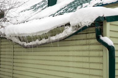 buckling gutter with snow and icicles in Greater Lansing Michigan
