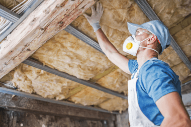 Greater Lansing roofing contractor inspecting old insulation