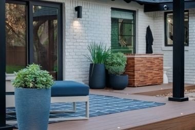 composite deck project with recessed lighting and sconce light fixture