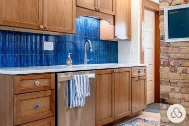 luxury kitchen remodeling project in Greater Lansing Michigan built by Custom Built Design and Remodeling with fluted blue tile backsplash and custom cabinet hardware