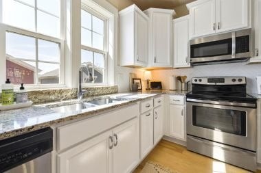small kitchen remodeling project with white cabinets and granite countertops in Greater Lansing