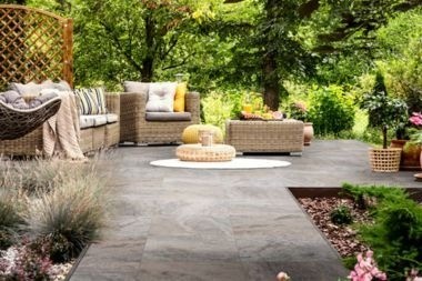 Greater Lansing patio with natural stone pavers and outdoor furniture