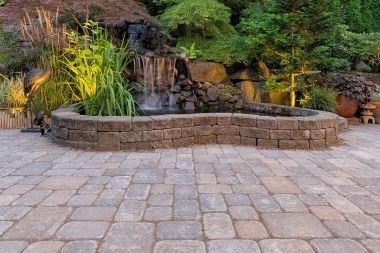 brick paver patio with waterfall in Greater Lansing outdoor living space