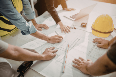 Greater Lansing remodeling team reviewing project blueprints