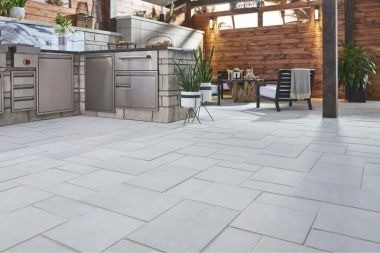 Greater Lansing outdoor living space with kitchen and limestone pavers