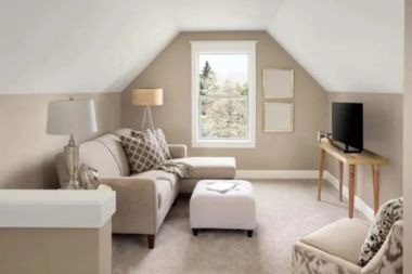 living space with couch and TV above garage addition Greater Lansing
