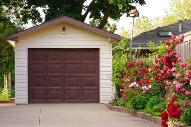 detached garage addition with brown door in Greater Lansing