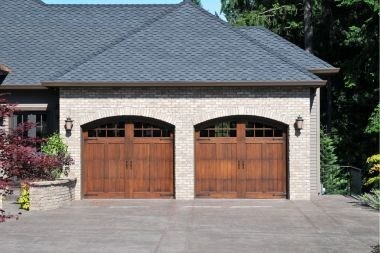 garage addition in Greater Lansing with double doors and sconce lighting