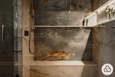 luxury bathroom remodeling project with shower bench and glass door built by Custom Built Design and Remodeling in Greater Lansing Michigan