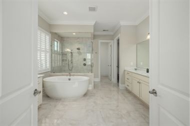 spacious luxury bathroom remodeling with freestanding tub and long vanity in Greater Lansing