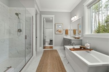 large luxury bathroom remodeling project with freestanding tub and glass shower door in Greater Lansing