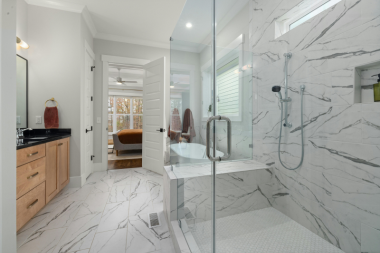 Greater Lansing luxury bathroom remodeling project with glass enclosed shower and quartz tile