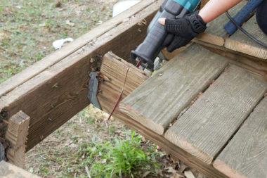Greater Lansing deck builder sawing wood decking joist