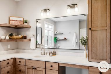luxury bathroom remodeling project in Greater Lansing Michigan built by Custom Built Design and Remodeling with large vanity and track lighting
