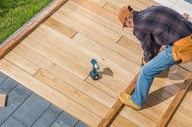 Greater Lansing deck contractor installing wood decking boards