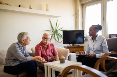 Greater Lansing homeowners discussing insurance policies with agent