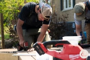 Greater Lansing composite deck builders installing decking boards at Custom Built Design and Remodeling project