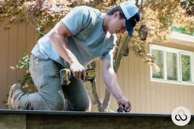 Greater Lansing composite deck builder installing decking boards for Custom Built Design and Remodeling