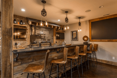 Greater Lansing basement remodeling project with wet bar and industrial fixtures
