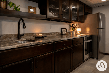 basement wet bar with glass front cabinets and countertop in Greater Lansing built by Custom Built Design and Remodeling