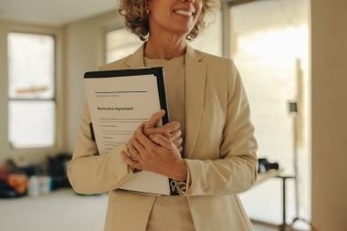 Greater Lansing home addition contractor holding clipboard during in home consultation