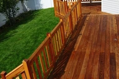 wood decking project with railings and backyard space
