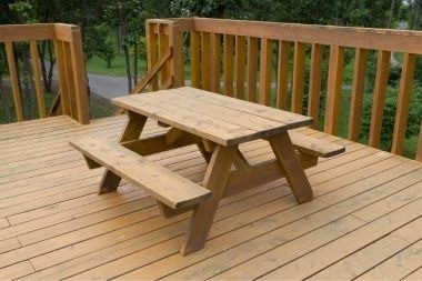 wood deck outdoor living space with picnic bench