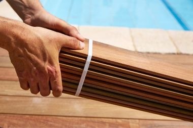 composite deck builder holding decking boards