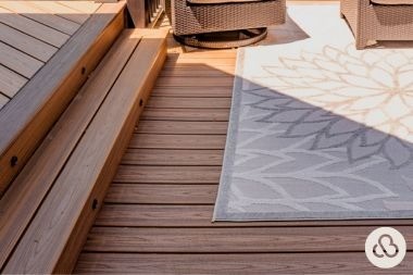 composite deck project in DeWitt Michigan built by Custom Built Design and Remodeling with trex boards and rug