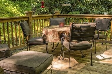 wood deck outdoor living space with dining table and wood railings