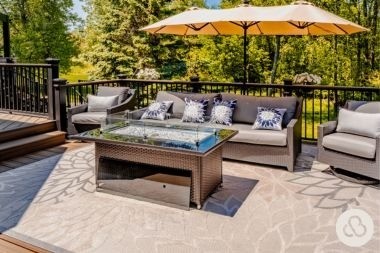 composite deck project in dewitt michigan built by Custom Built Design and Remodeling with fire table and outdoor furniture