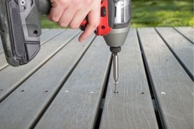 Greater Lansing composite deck builder installing decking boards