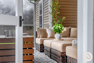 what to expect during a home addition project covered composite deck living space with outdoor furniture and fire table custom built michigan