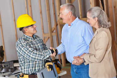 what to expect during a home addition project remodeling contractor shaking hands with homeowners custom built michigan