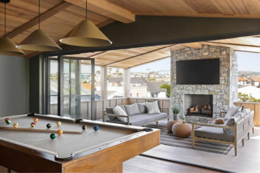 top home remodeling ideas for sports fans covered deck outdoor living space with couches and fireplace custom built michigan